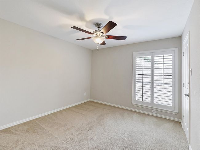 Carpeted spare room featuring ceiling fan and baseboards | Image 35