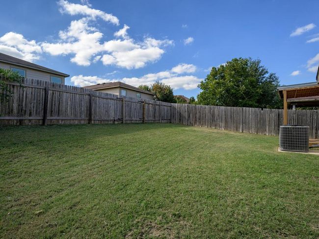 View of fenced backyard. | Image 28