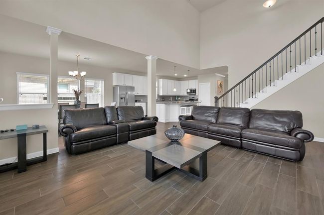Another view highlights the wrought iron spindle staircase with the rich warm banister. Every detail counts! | Image 13