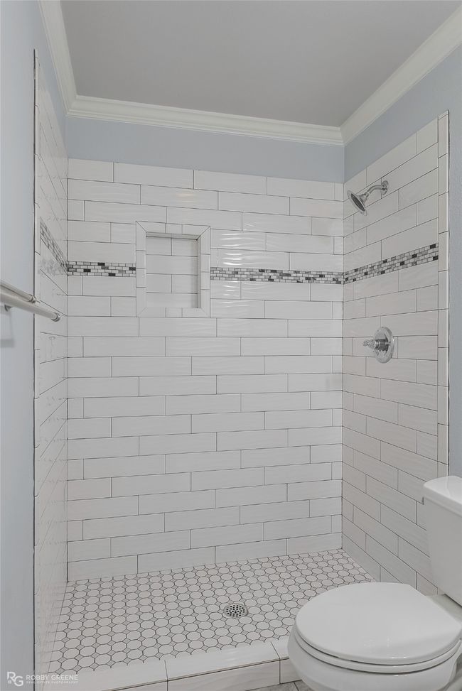Bathroom with a shower stall, toilet, and ornamental molding | Image 17