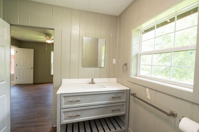 Bathroom with vanity, wood finished floors, and a ceiling fan | Image 22