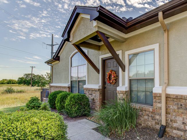 Doorway to property featuring stucco siding and brick siding | Image 20