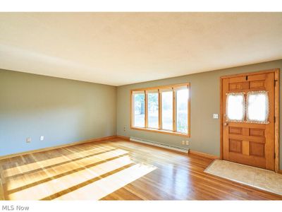 Entrance foyer with a baseboard radiator and light hardwood / wood-style flooring | Image 3