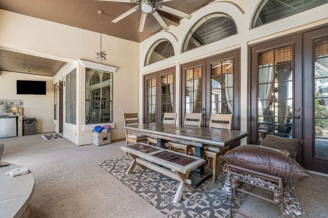 View of patio / terrace with outdoor dining area, a ceiling fan, and french doors | Image 23