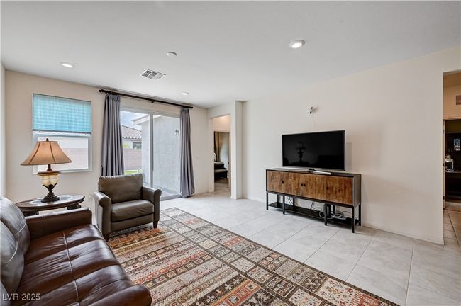 Living area with light tile patterned floors, baseboards, and recessed lighting | Image 7