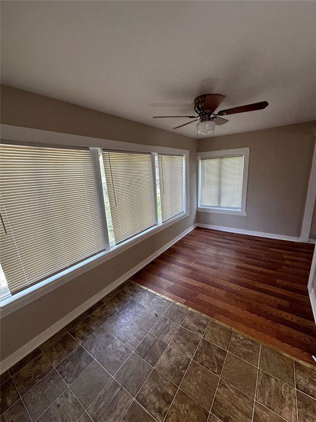 Unfurnished room featuring ceiling fan and dark wood-type flooring | Image 4