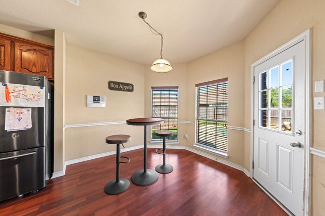 Dining room featuring dark wood-type flooring and baseboards | Image 11