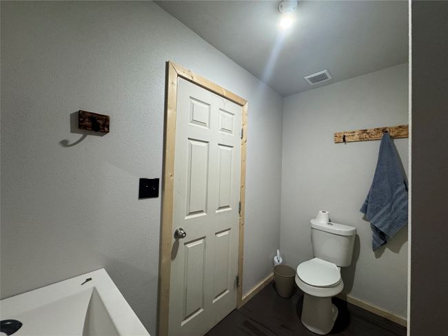 Bathroom with toilet and wood finished floors | Image 15