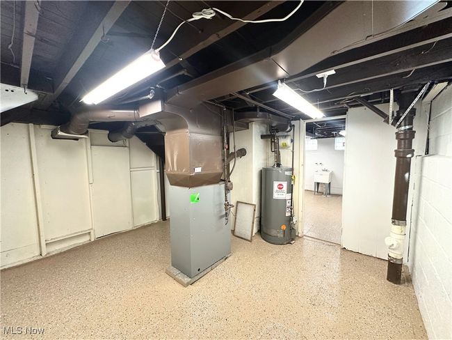 Basement with water heater, heating unit, and a sink | Image 15
