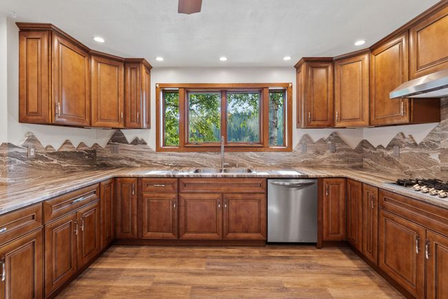 Abundant cupboard and counter space with views looking out to the lake | Image 22