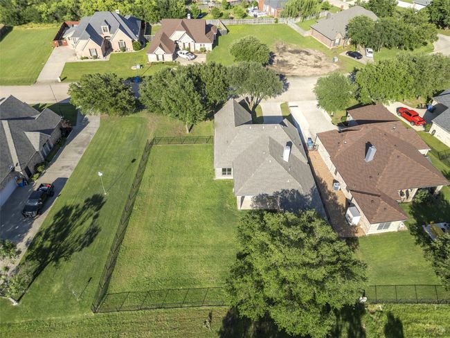 Backyard Aerial View showing wrought iron black fence surrounding back yard. | Image 34