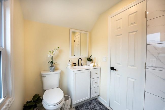 Bathroom with toilet, vanity, and vaulted ceiling | Image 30