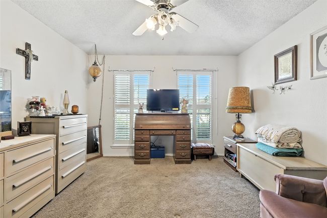 Living room featuring a ceiling fan, light carpet, and a textured ceiling | Image 27