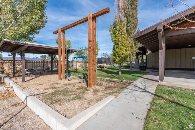 View of yard featuring a playground and a trampoline | Image 6