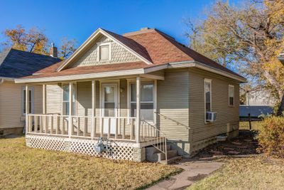 View of front of house with a porch, a front lawn, and cooling unit | Image 2