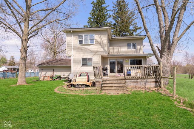 rear view of property featuring a yard and a wooden deck | Image 30
