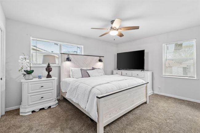 Bedroom with carpet flooring, ceiling fan, and baseboards | Image 25