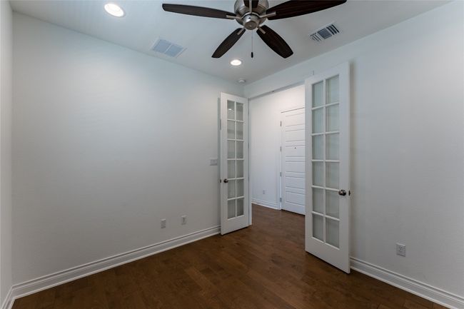 Spare room featuring french doors, dark wood finished floors, recessed lighting, and a ceiling fan | Image 11