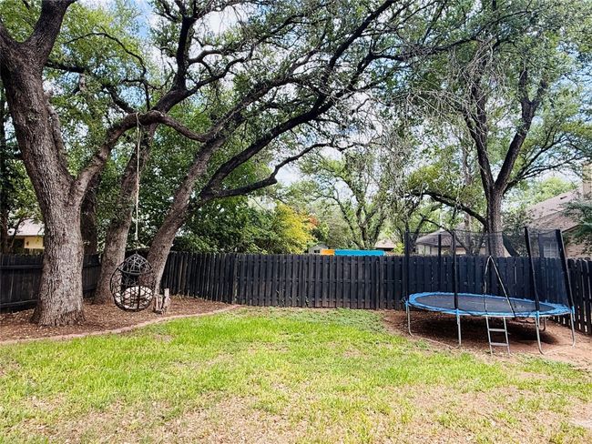 View of yard featuring a trampoline | Image 34