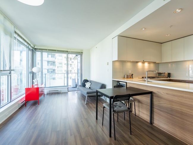 Dining area with healthy amount of natural light and dark wood-style flooring | Image 9