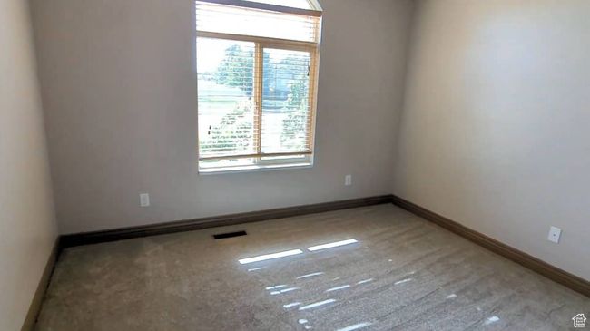 Spare room featuring healthy amount of natural light, baseboards, and carpet floors | Image 26