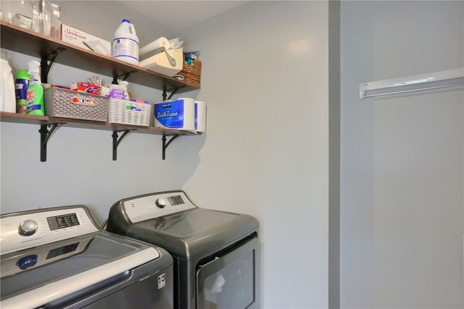 Spacious laundry room with floating shelves added for tons of storage | Image 36