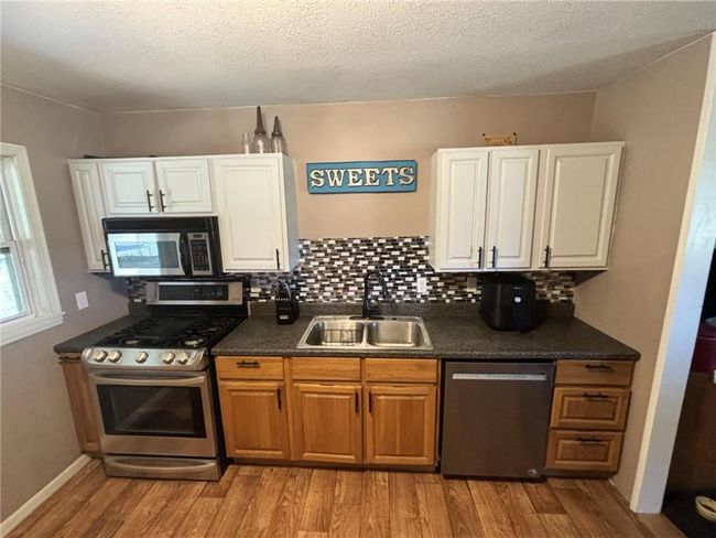 Kitchen featuring stainless steel appliances and laminate flooring | Image 10