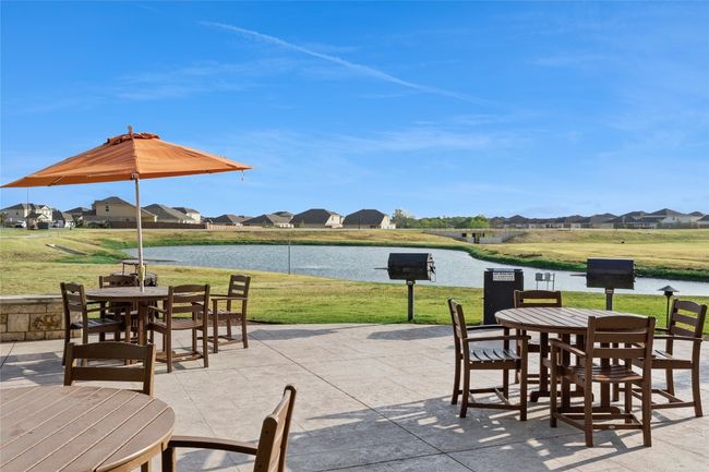 View of patio / terrace with outdoor dining area, a residential view, and a water view | Image 21