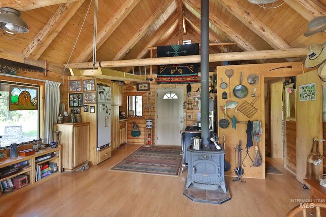 Misc room with a wooden ceiling with exposed beams, a wood stove, plenty of natural light, high vaulted ceiling, and wood finished floors | Image 8