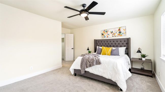 Carpeted bedroom with baseboards and a ceiling fan | Image 24