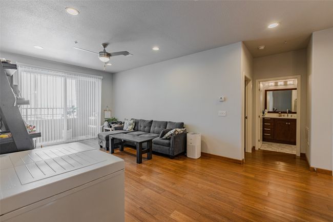 Living area with light wood finished floors, ceiling fan, and recessed lighting | Image 11