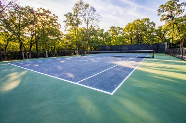 View of tennis court with community basketball court and fence | Image 32