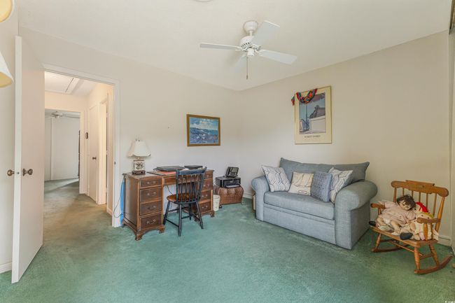 Home office with carpet flooring, a ceiling fan, and attic access | Image 20