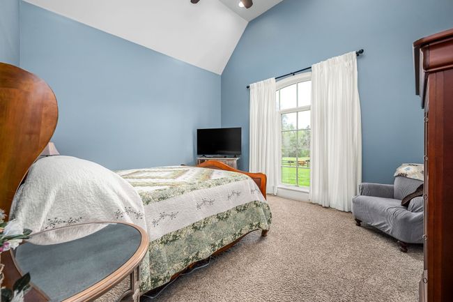 A primary suite with high ceiling adds spaciousness, while large windows or skylights fill the room with a warm, inviting glow. This combination creates a serene retreat perfect for relaxation. | Image 53