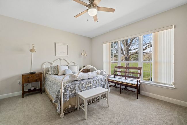 Bedroom featuring baseboards, multiple windows, and light carpet | Image 17