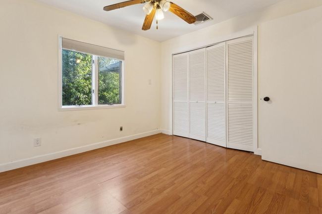 Unfurnished bedroom featuring baseboards, visible vents, light wood-style floors, a ceiling fan, and a closet | Image 20