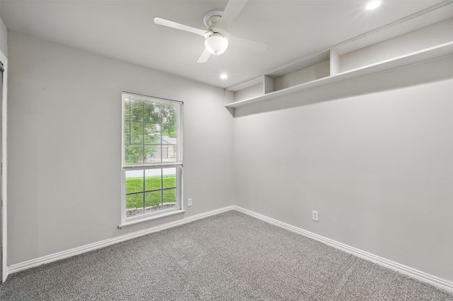 Carpeted empty room with ceiling fan, recessed lighting, and baseboards | Image 12
