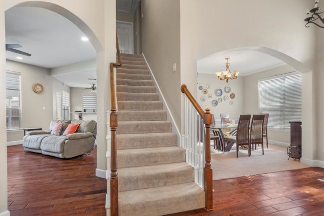 Stairs with a ceiling fan, wood-type flooring, arched walkways, plenty of natural light, and recessed lighting | Image 27