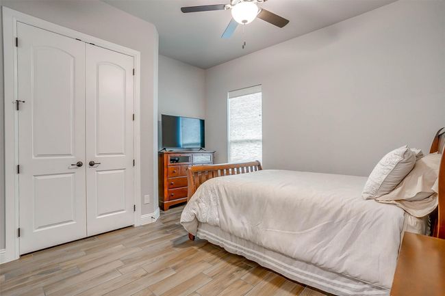 Bedroom featuring light wood-type flooring, a closet, and ceiling fan | Image 26