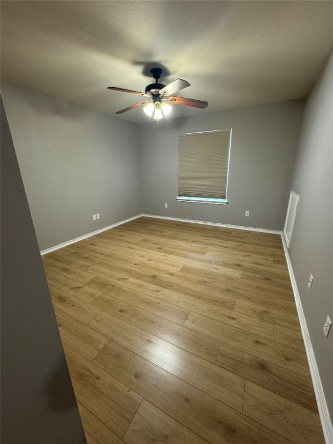 Spare room featuring a ceiling fan, wood finished floors, and baseboards | Image 23