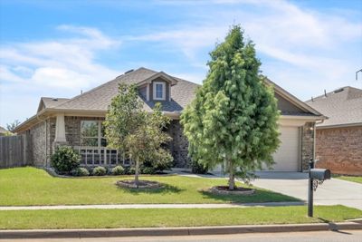 View of front of property with a garage and a front lawn | Image 1