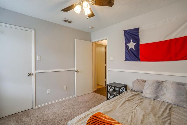 Carpeted bedroom with a ceiling fan | Image 23