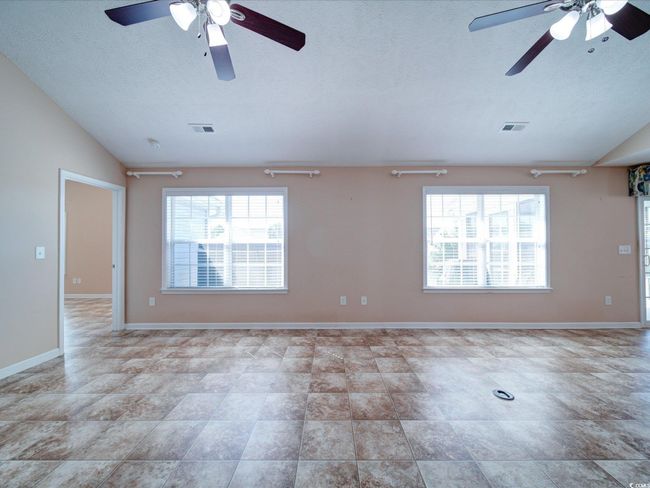 Spare room with a ceiling fan, vaulted ceiling, and a textured ceiling | Image 14