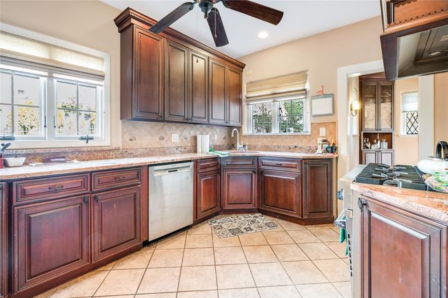 Kitchen featuring the stove, dishwasher, and sink | Image 8