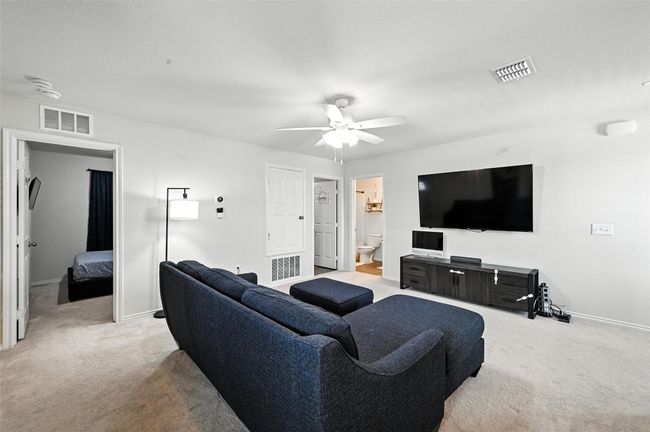 Living room featuring light carpet and ceiling fan | Image 19