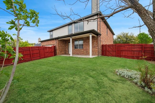 Back of property featuring a yard, a fenced backyard, and brick siding | Image 6