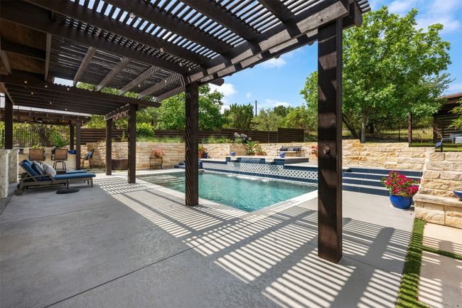View of pool featuring a fenced backyard, a patio area, and a pergola | Image 26