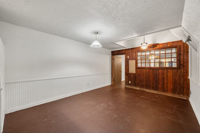 Unfurnished dining area featuring painted concrete flooring | Image 11