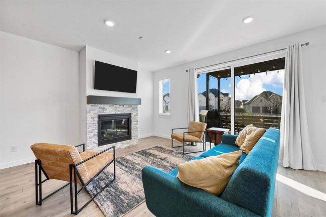 Living room featuring a fireplace and light wood-type flooring | Image 9