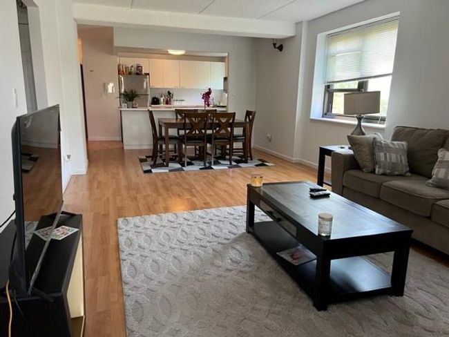 Living area with light wood finished floors and baseboards | Image 10